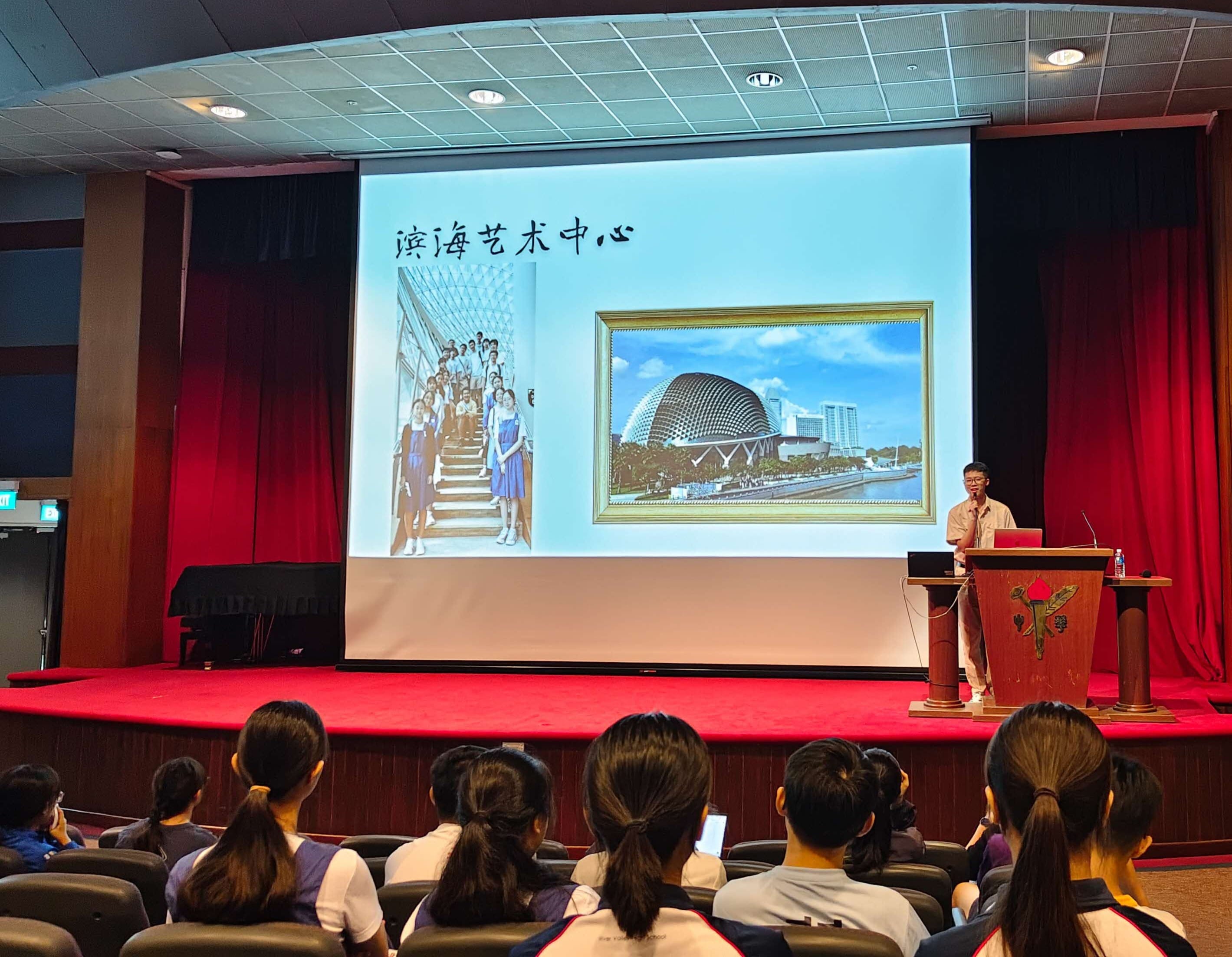 A student sharing his takeaways of the learning journey on stage